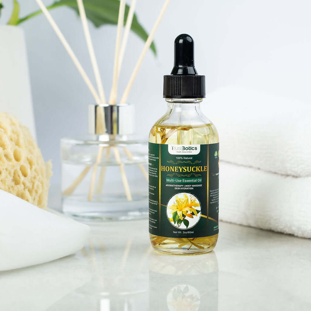 Honeysuckle Essential Oil bottle by TrustBotics on a spa-style setup with towel, sponge, and diffuser, highlighting luxury skincare.