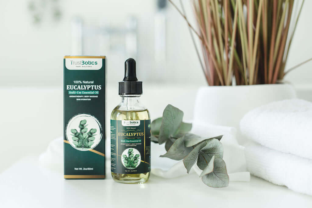 TrustBotics Eucalyptus Multi-Use Essential Oil with packaging, eucalyptus leaves, and spa towels, styled to highlight freshness and luxurious natural skincare.