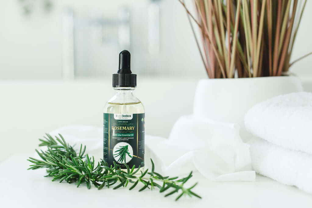 TrustBotics Rosemary Multi-Use Essential Oil bottle with fresh rosemary sprigs, embodying luxury herbal aroma.