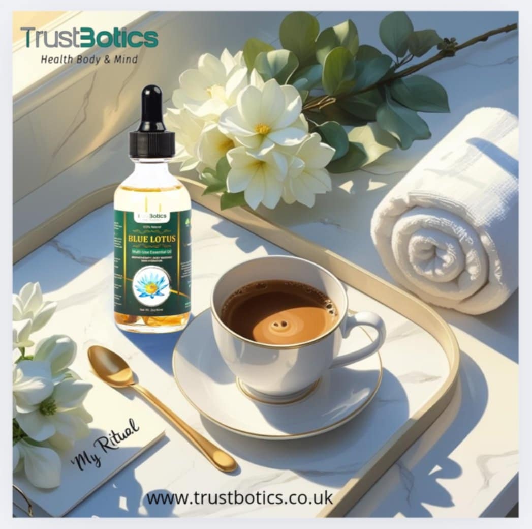 TrustBotics Blue Lotus essential oil bottle with morning coffee, white flowers, rolled towel, and notepad labeled “My Ritual” on marble tray.