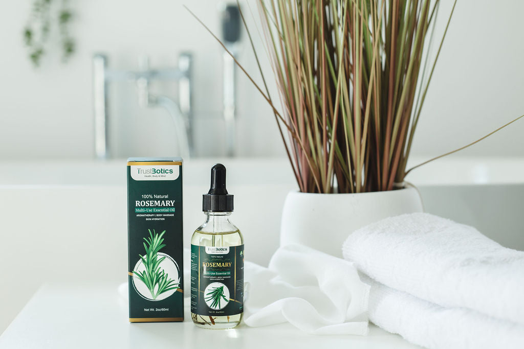 TrustBotics Rosemary Essential Oil bottle with packaging, displayed on spa towels with natural decor, emphasizing premium skincare and wellness.

