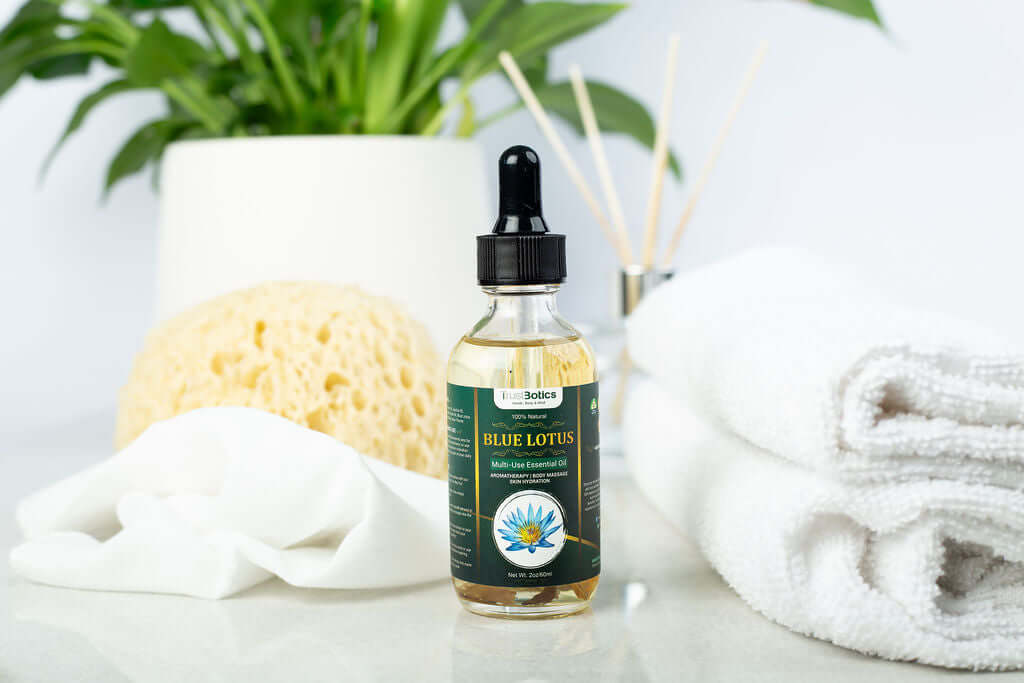 TrustBotics Blue Lotus Multi-Use Essential Oil bottle with natural spa items for relaxation and beauty care.
